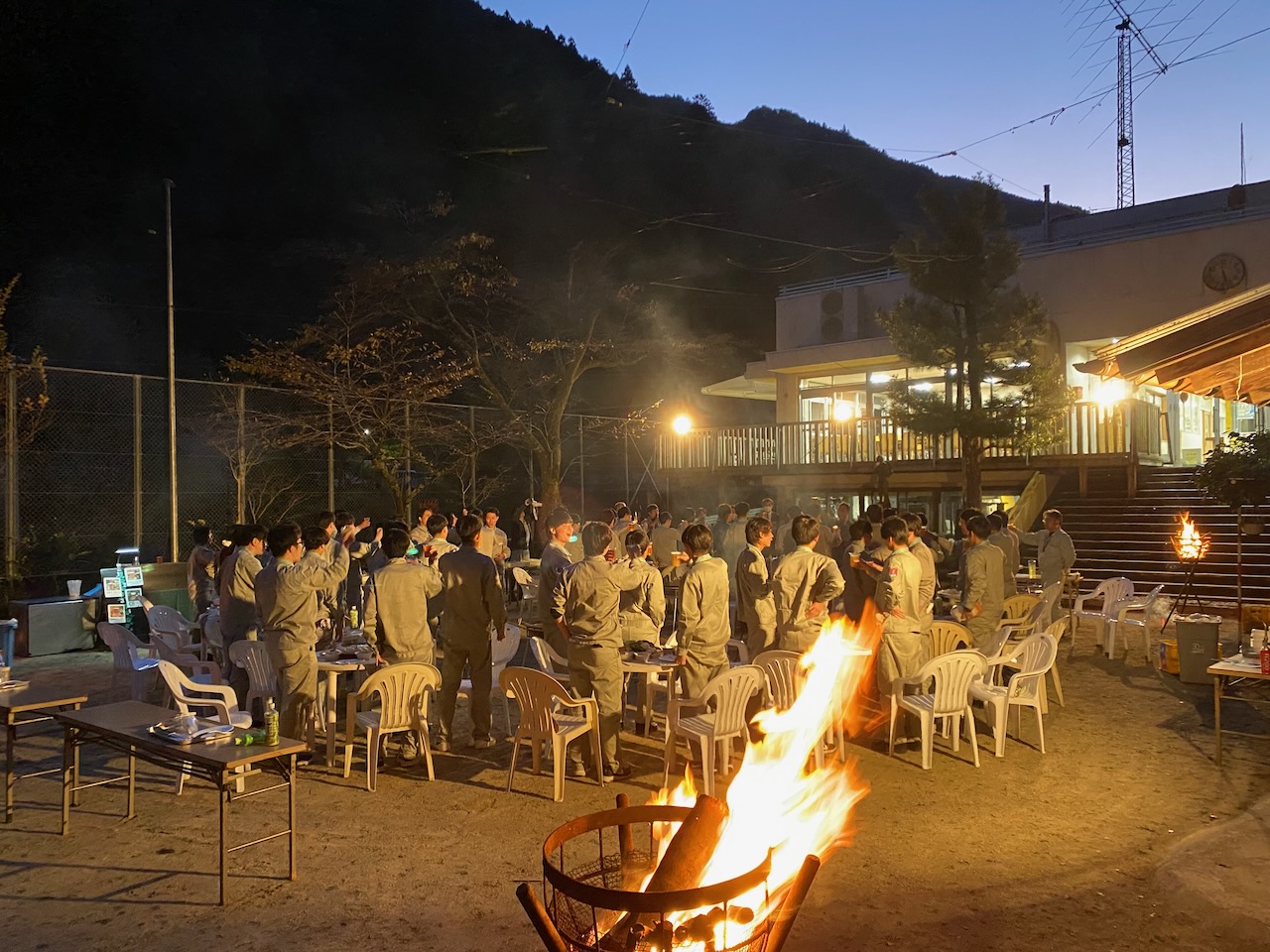 Large group gathering for an outdoor evening BBQ in the playground at Shimonanosato, Niyodogawa, Kochi.